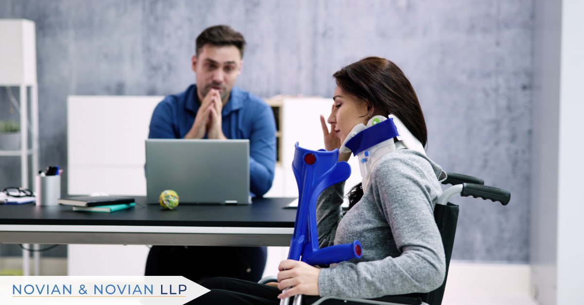 Injured client in a wheelchair with a neck brace meeting a personal injury attorney