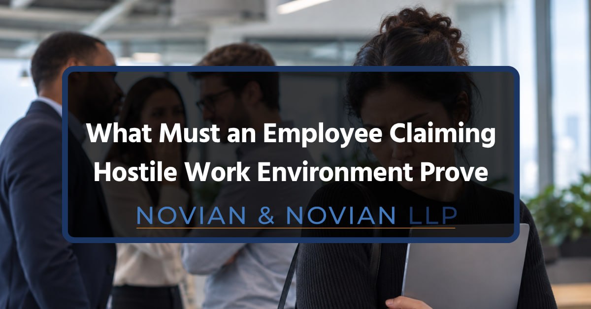 Hostile Work Environment Claims Woman holding a laptop in an office while coworkers talk in the background, representing a hostile work environment.